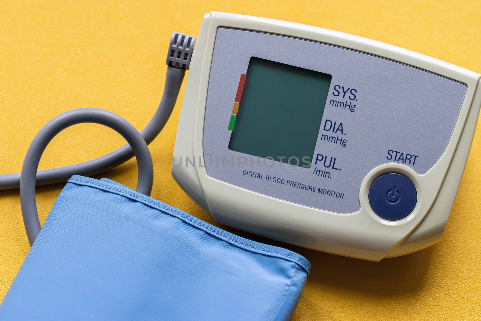 modern medical electronic tonometer on a bright yellow background.