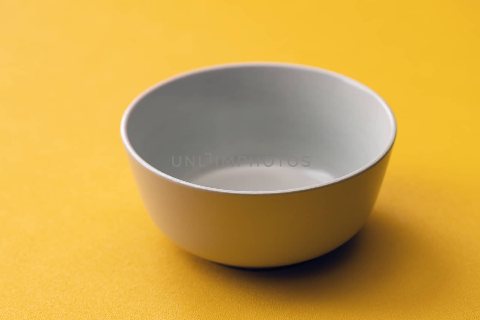Empty white Cup on a yellow background, isolate.