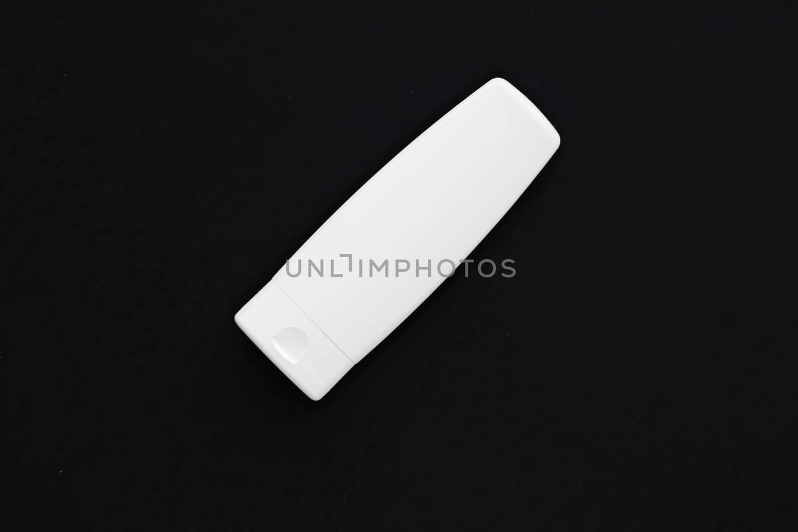 Blank label cosmetic container bottle as product mockup on black background, hygiene and healthcare