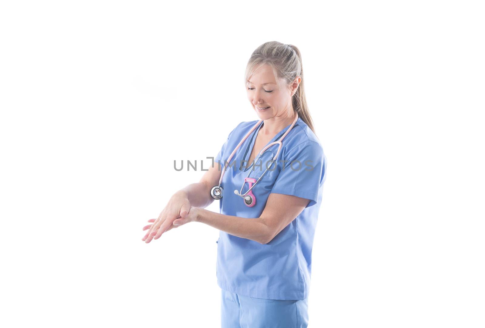 Nurse or doctor washing hands using an alcohol rub.  Hand hygiene before and after a procedure is essential practice