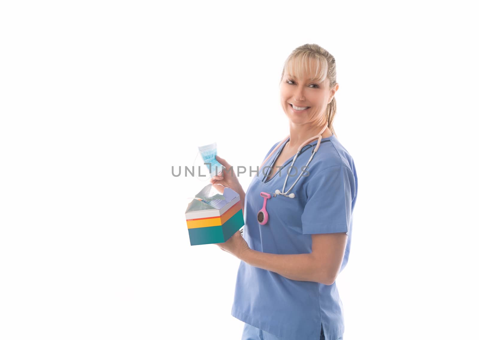 Friendly nurse in scrubs holding a box of surgical medical masks. Much needed PPE during flu season or pandemic such as coronavirus, SARS, MERS or other surgical procedures