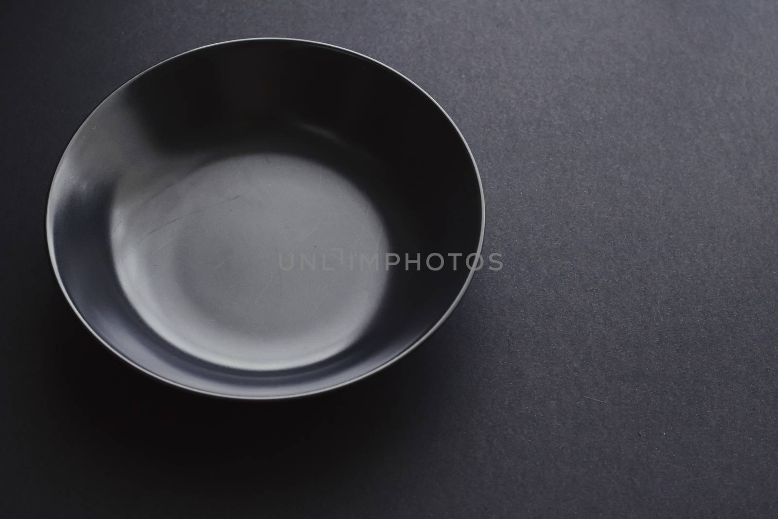 Empty plates on black background, premium dishware for holiday dinner, minimalistic design and diet concept