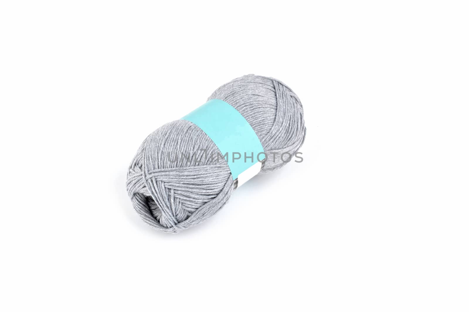 Tangle of color yarn with blank label on white background skein. Knitting isolated on white. Use for store