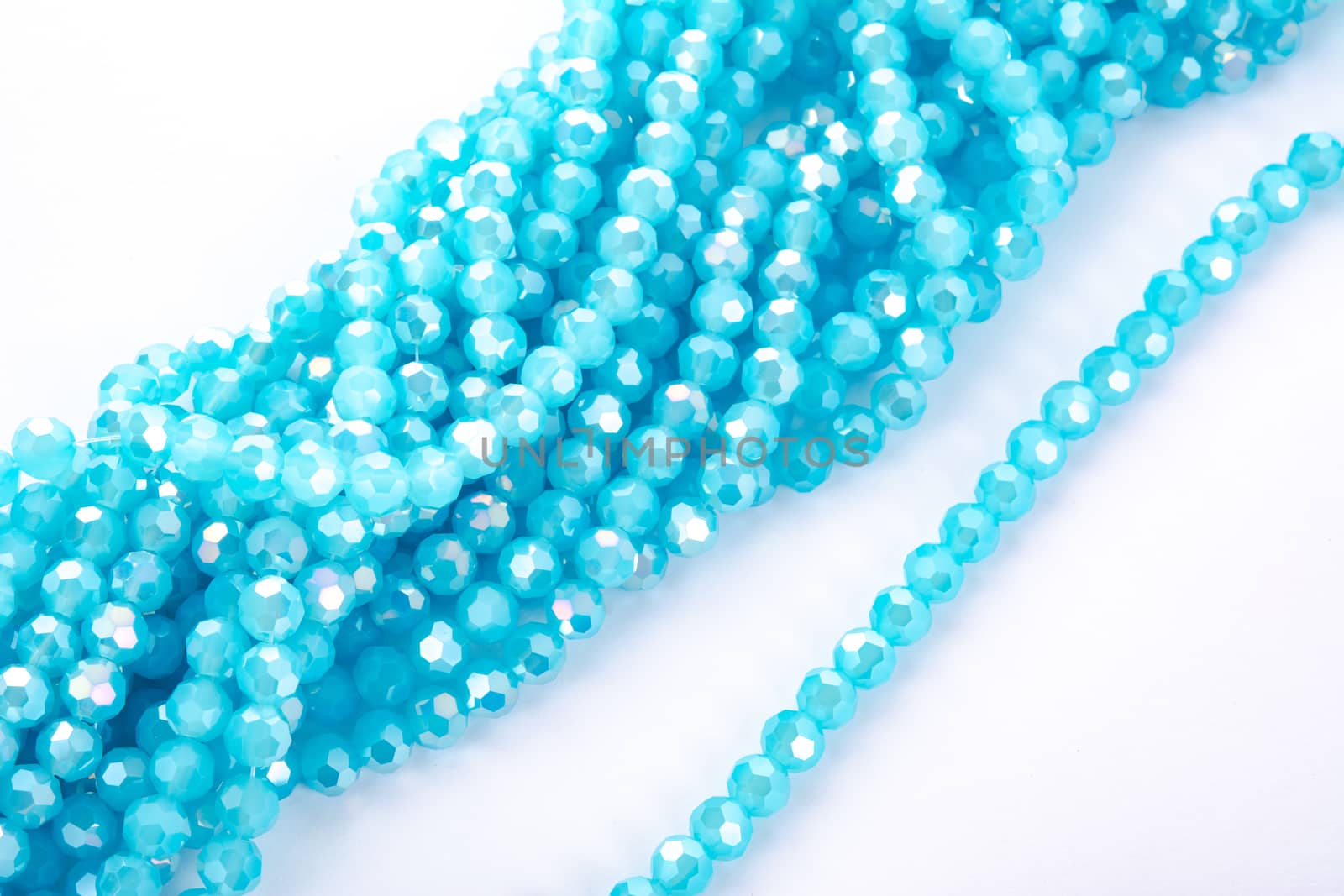Beautiful Light Blue Glass Sparkle Crystal Isoalted Beads on white background. Use for diy beaded jewelry