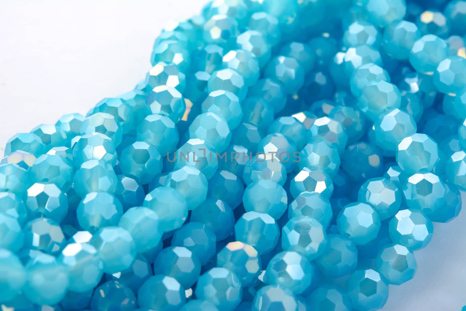 Beautiful Light Blue Glass Sparkle Crystal Isoalted Beads on white background. Use for diy beaded jewelry