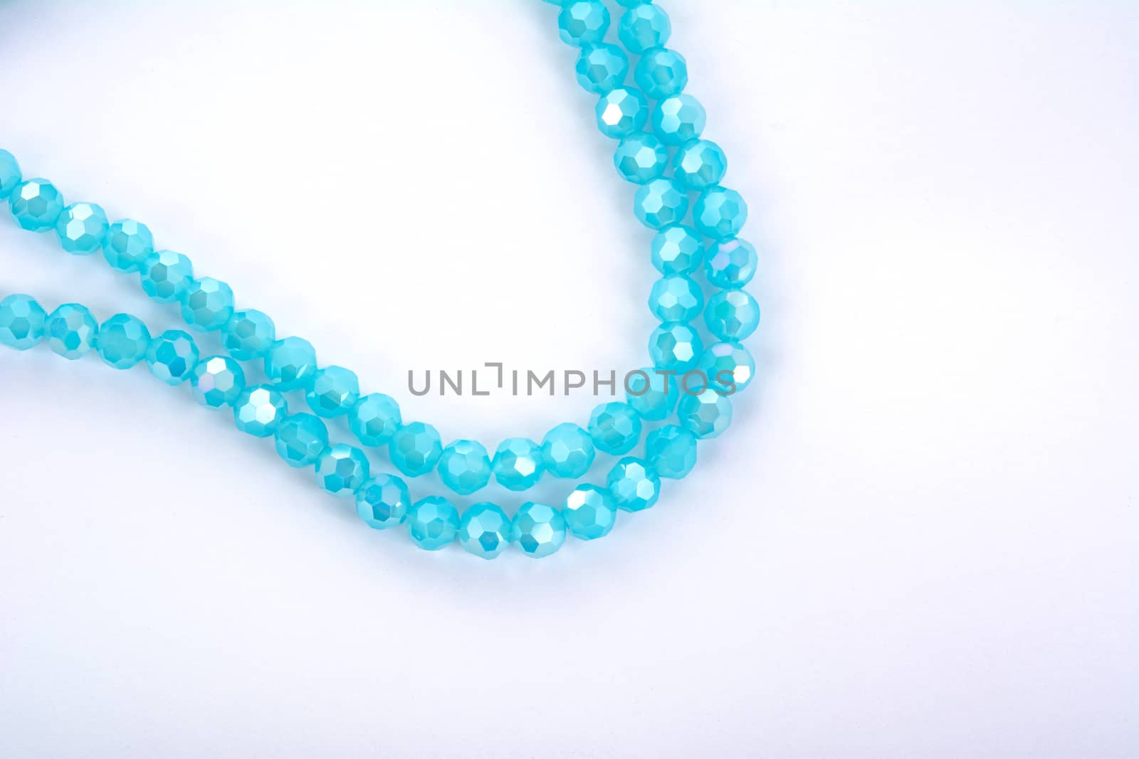 Beautiful Light Blue Glass Sparkle Crystal Isoalted Beads on white background. Use for diy beaded jewelry