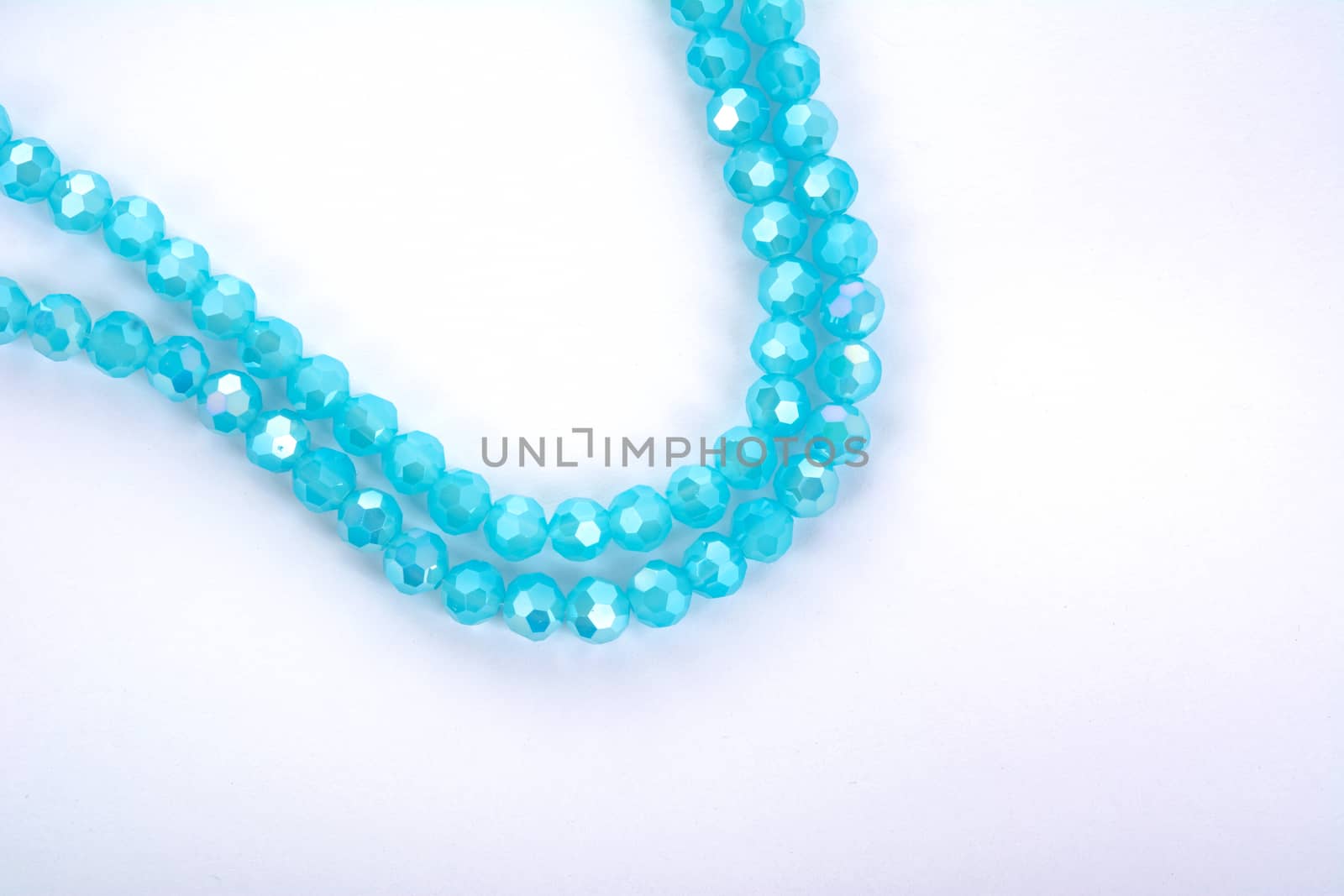 Beautiful Light Blue Glass Sparkle Crystal Isoalted Beads on white background. Use for diy beaded jewelry