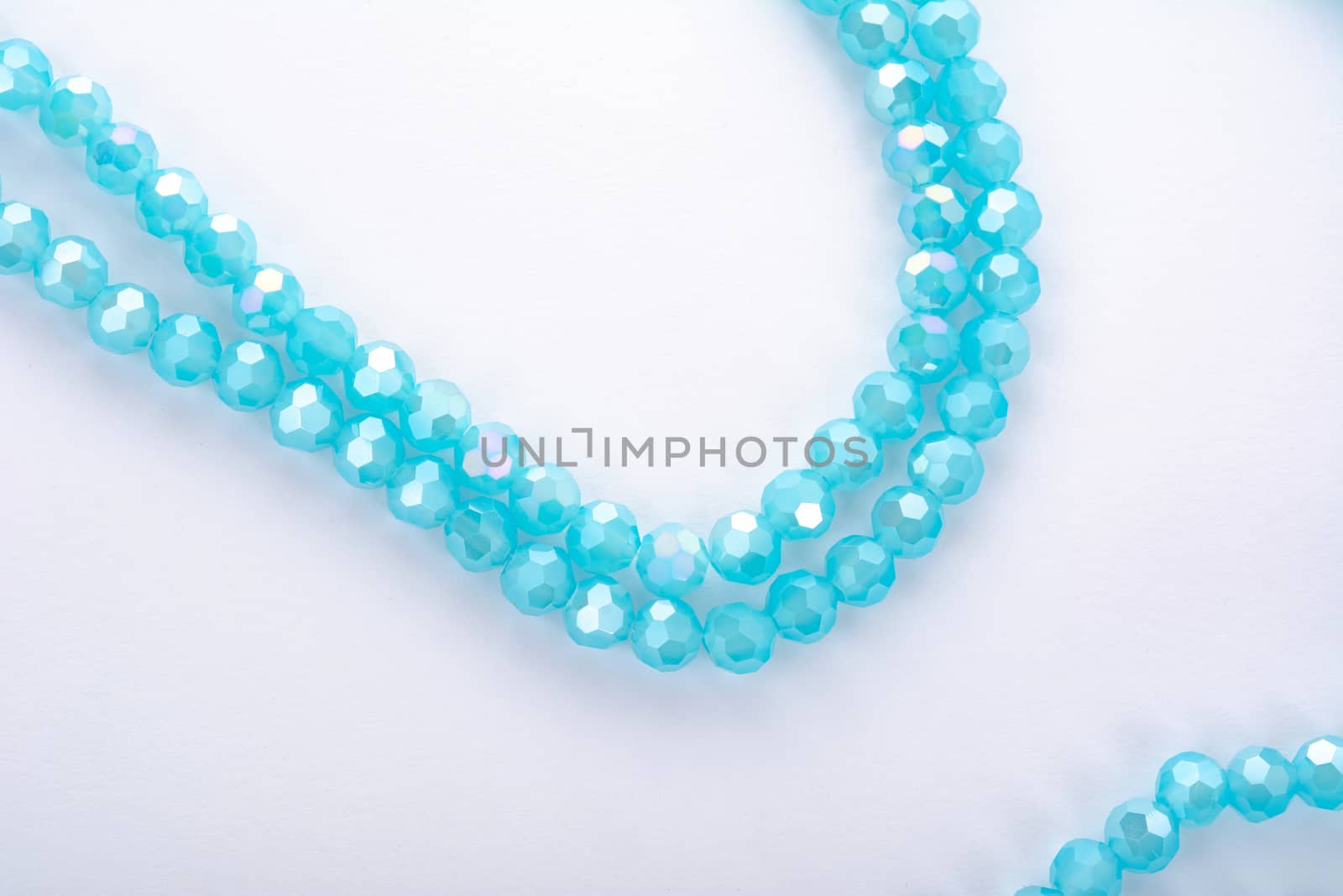 Beautiful Light Blue Glass Sparkle Crystal Isoalted Beads on white background. Use for diy beaded jewelry