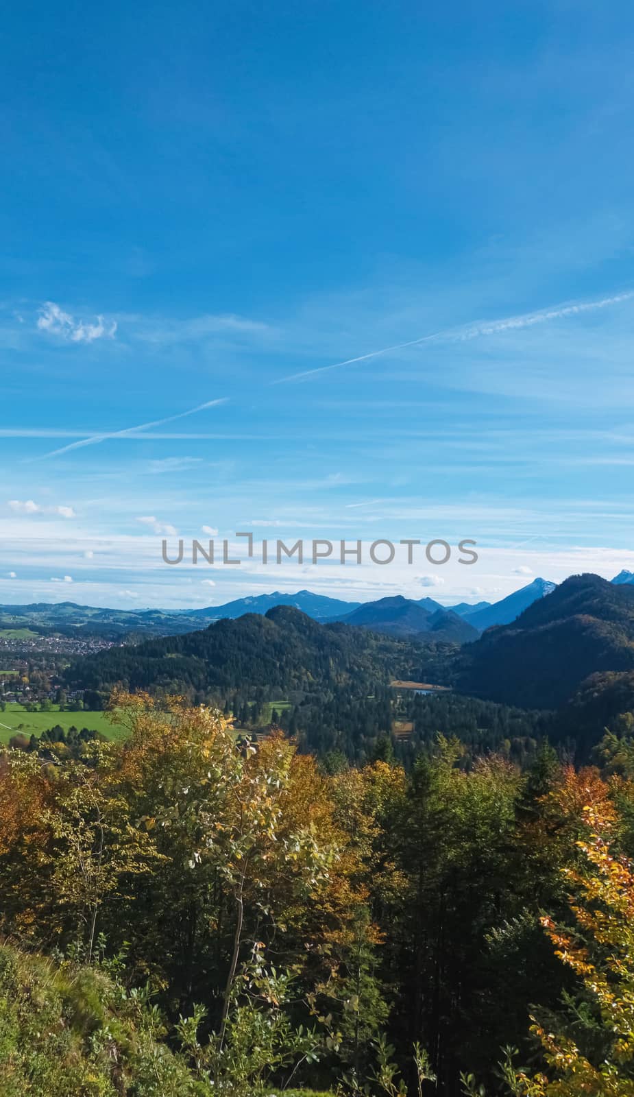 Beautiful nature of European Alps, landscape view of alpine mountains, lake and village on a sunny day, travel and destination scenery