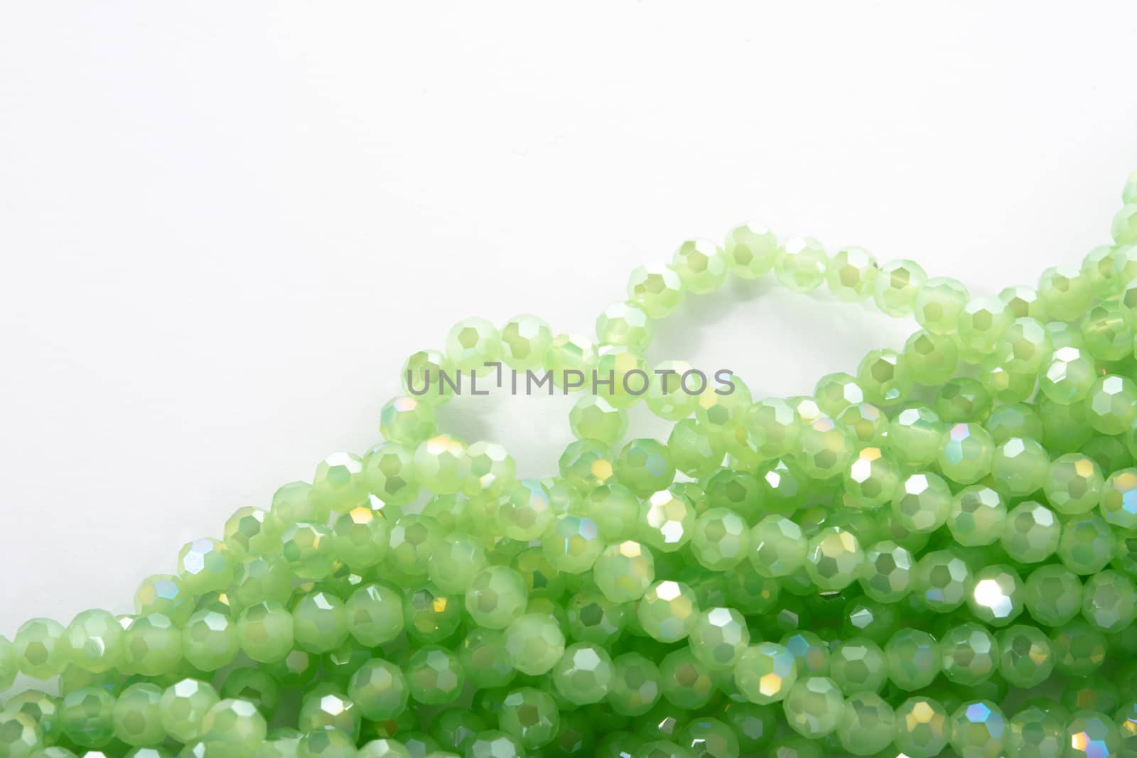Beautiful Light green Glass Sparkle Crystal Isoalted Beads on white background. Use for diy beaded jewelry