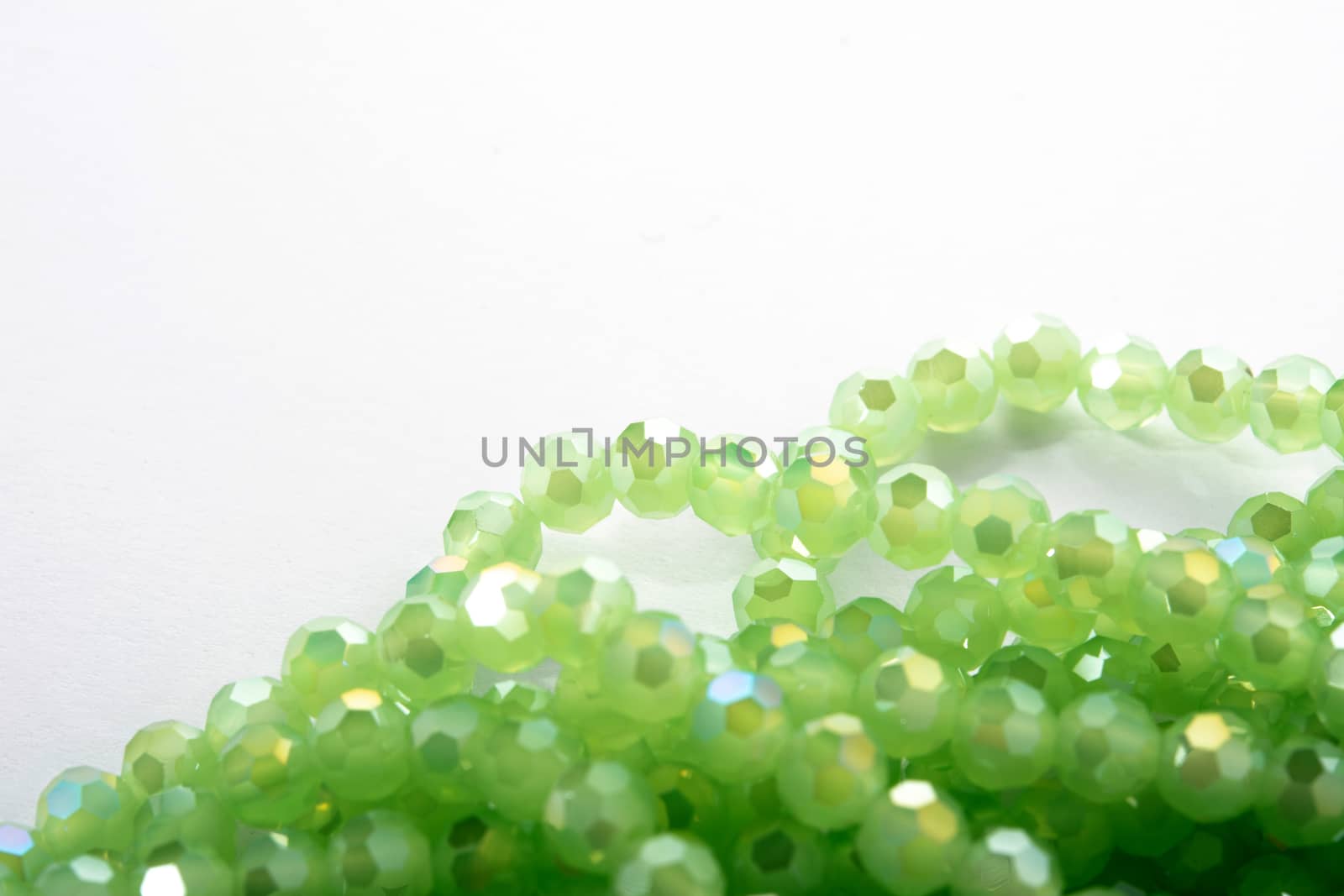 Beautiful Light green Glass Sparkle Crystal Isoalted Beads on white background. Use for diy beaded jewelry