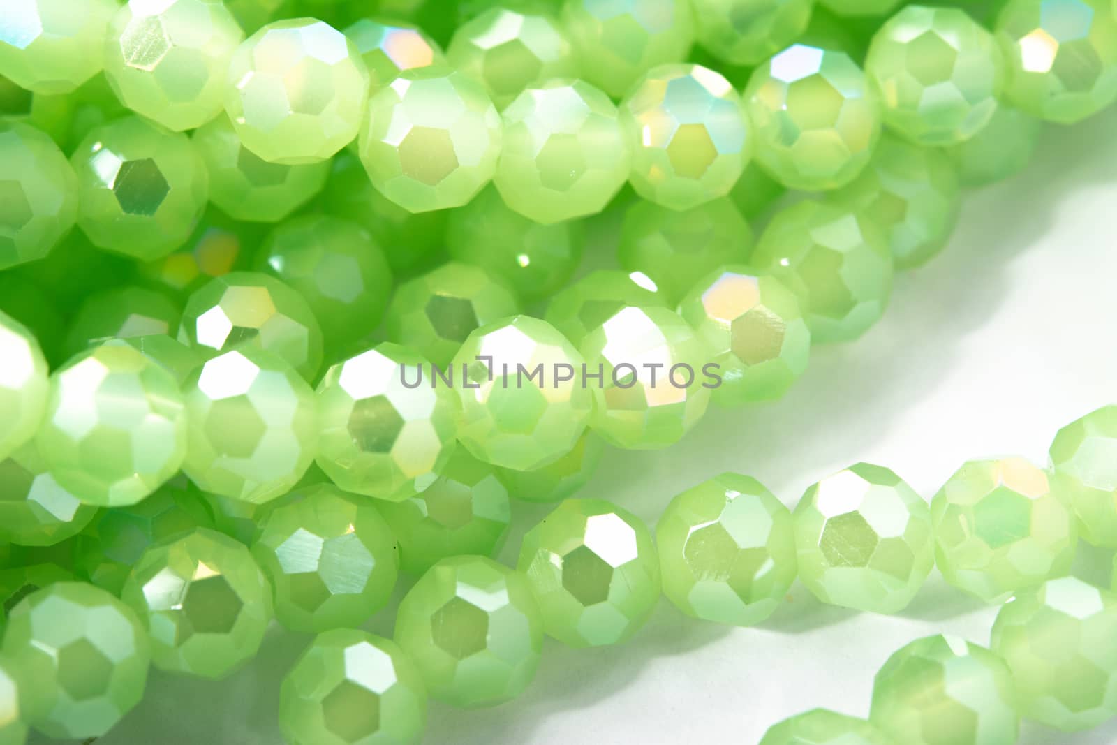 Beautiful Light green Glass Sparkle Crystal Isoalted Beads on white background. Use for diy beaded jewelry