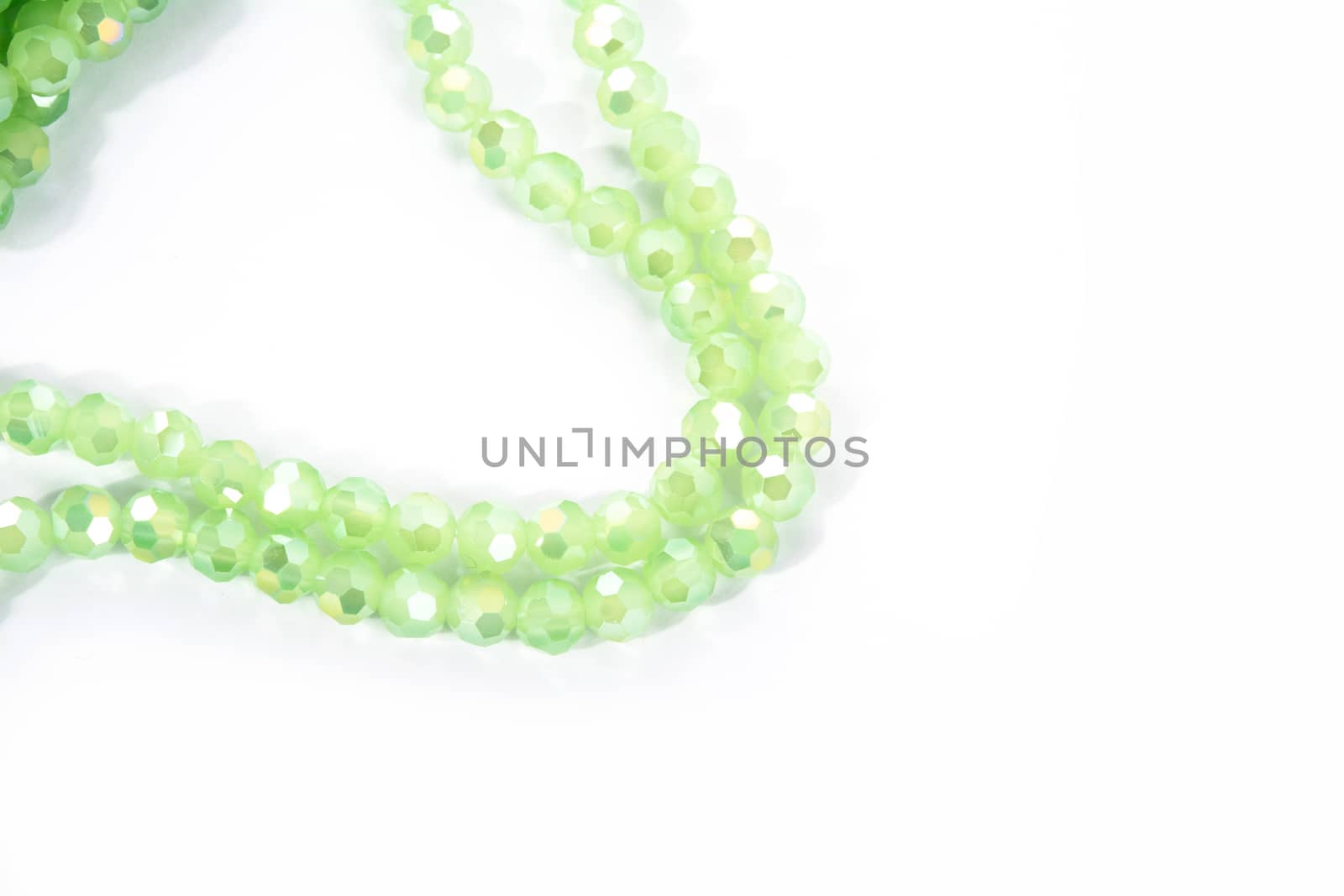 Beautiful Light green Glass Sparkle Crystal Isoalted Beads on white background. Use for diy beaded jewelry