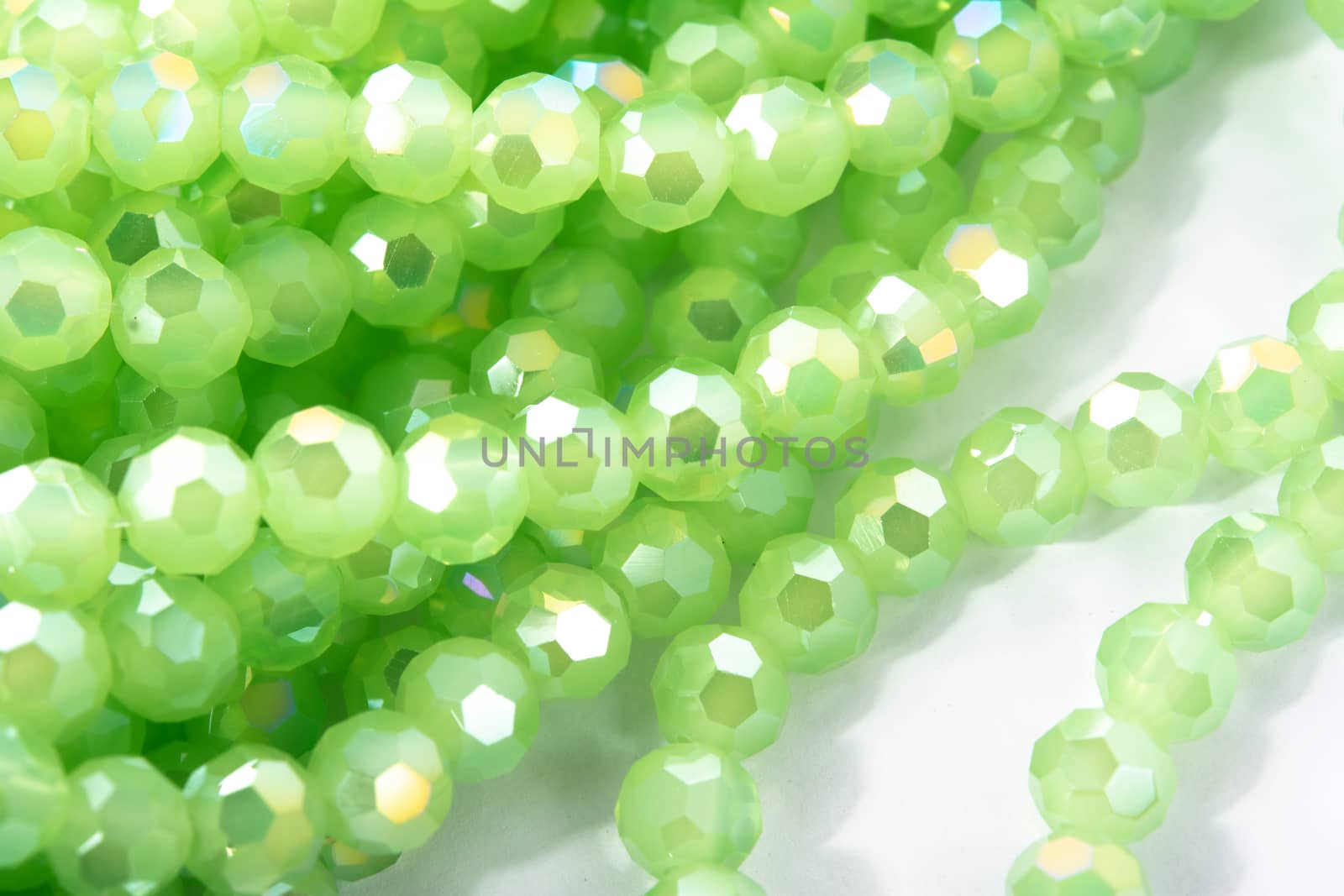 Beautiful Light green Glass Sparkle Crystal Isoalted Beads on white background. Use for diy beaded jewelry