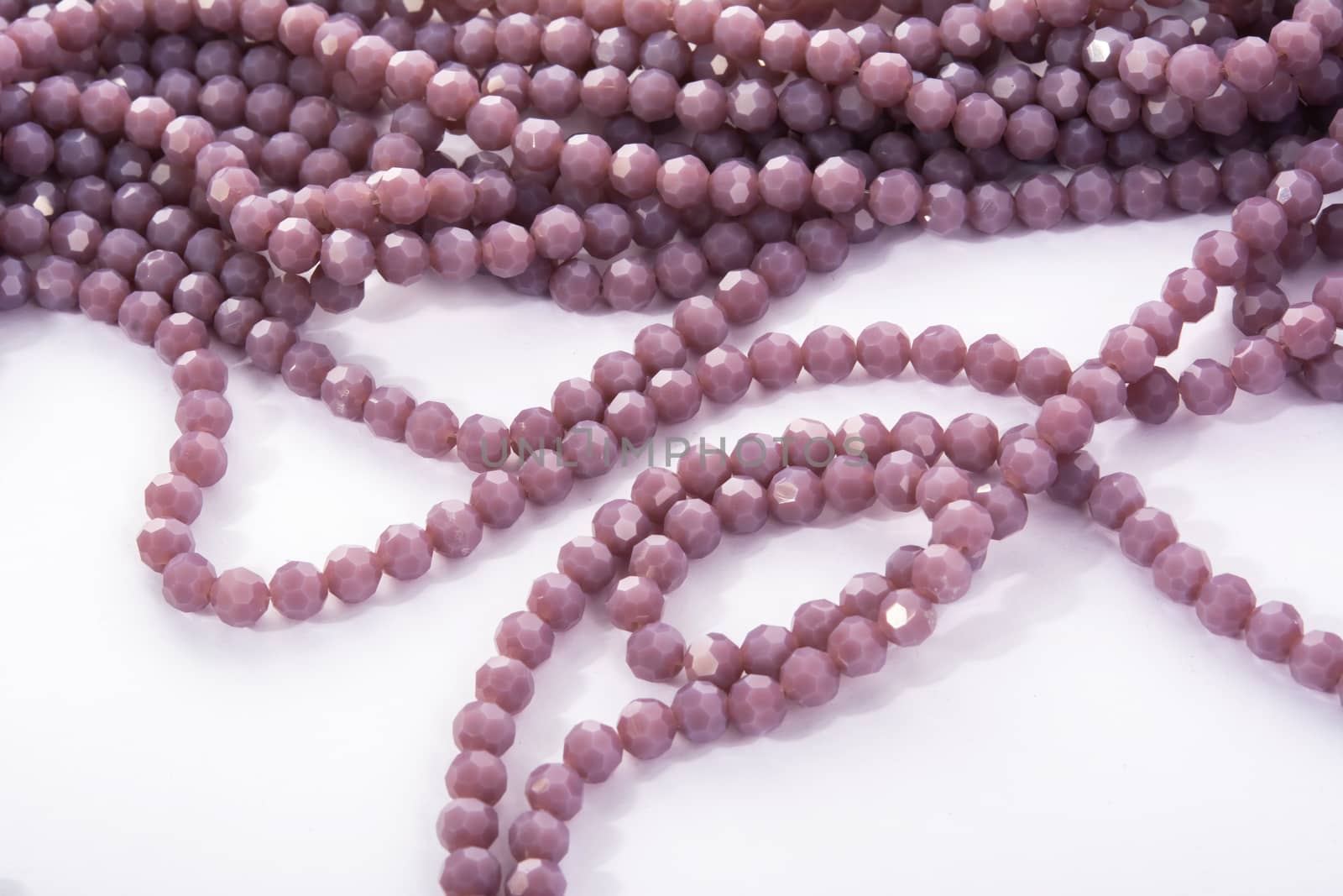 Beautiful Light purple Glass Sparkle Crystal Isoalted Beads on white background. Use for diy beaded jewelry