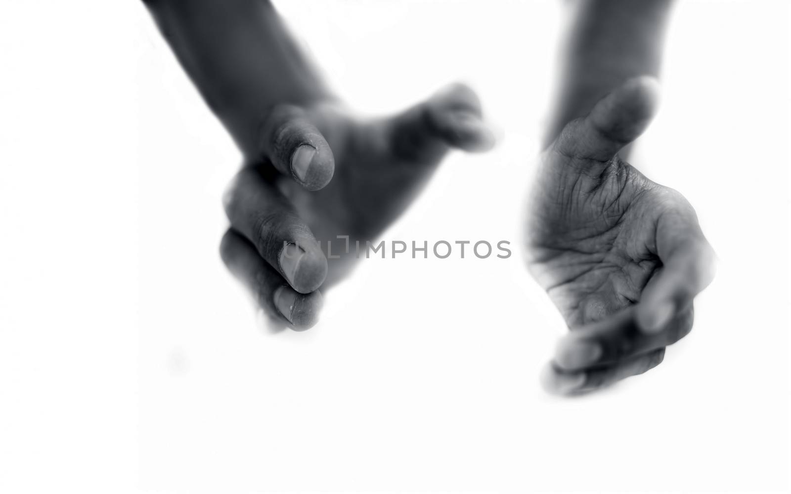 Close up of two hands imagery trying to help the one in need. by mirzamlk