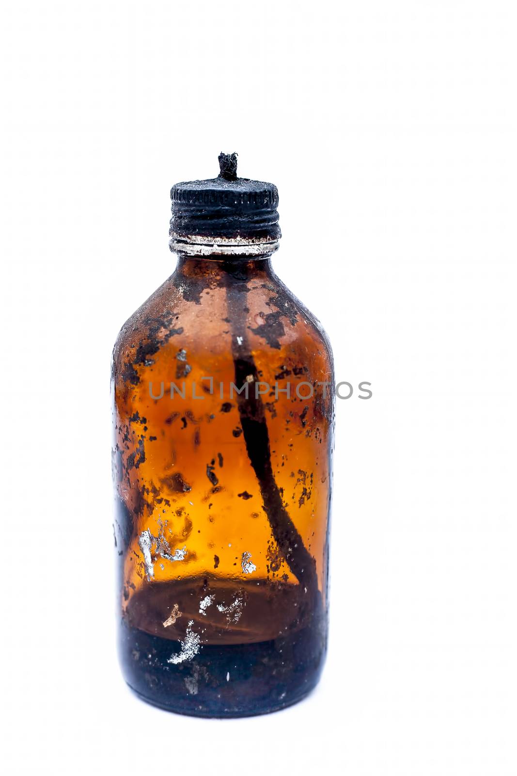 Close up of a bottle shaped kerosene lamp or oil lantern isolated on white burning.
