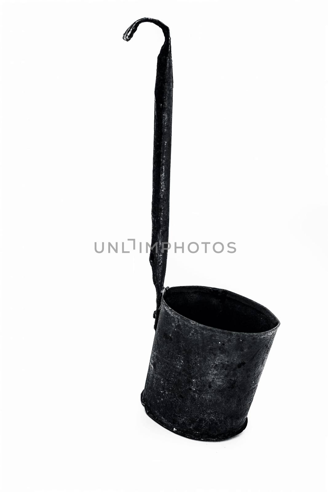 Close up of black colored metal liquid measuring domestic jug or cup isolated on white.