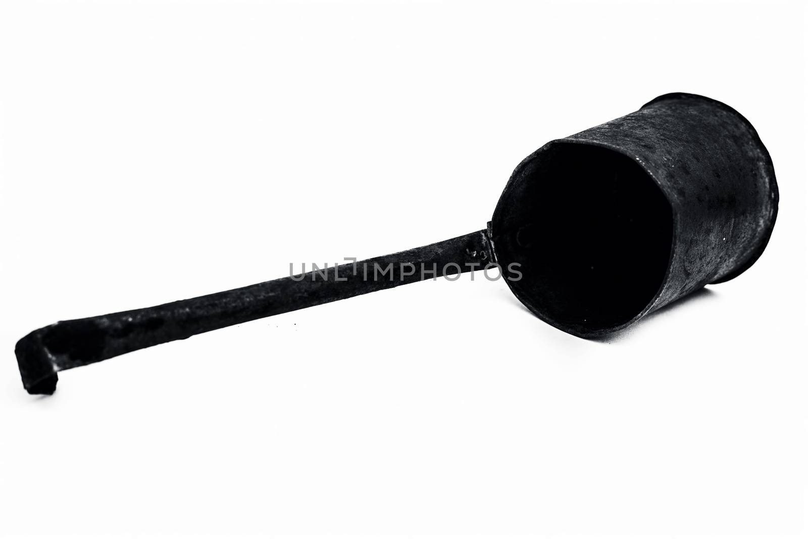 Close up of black colored metal liquid measuring domestic jug or cup isolated on white.