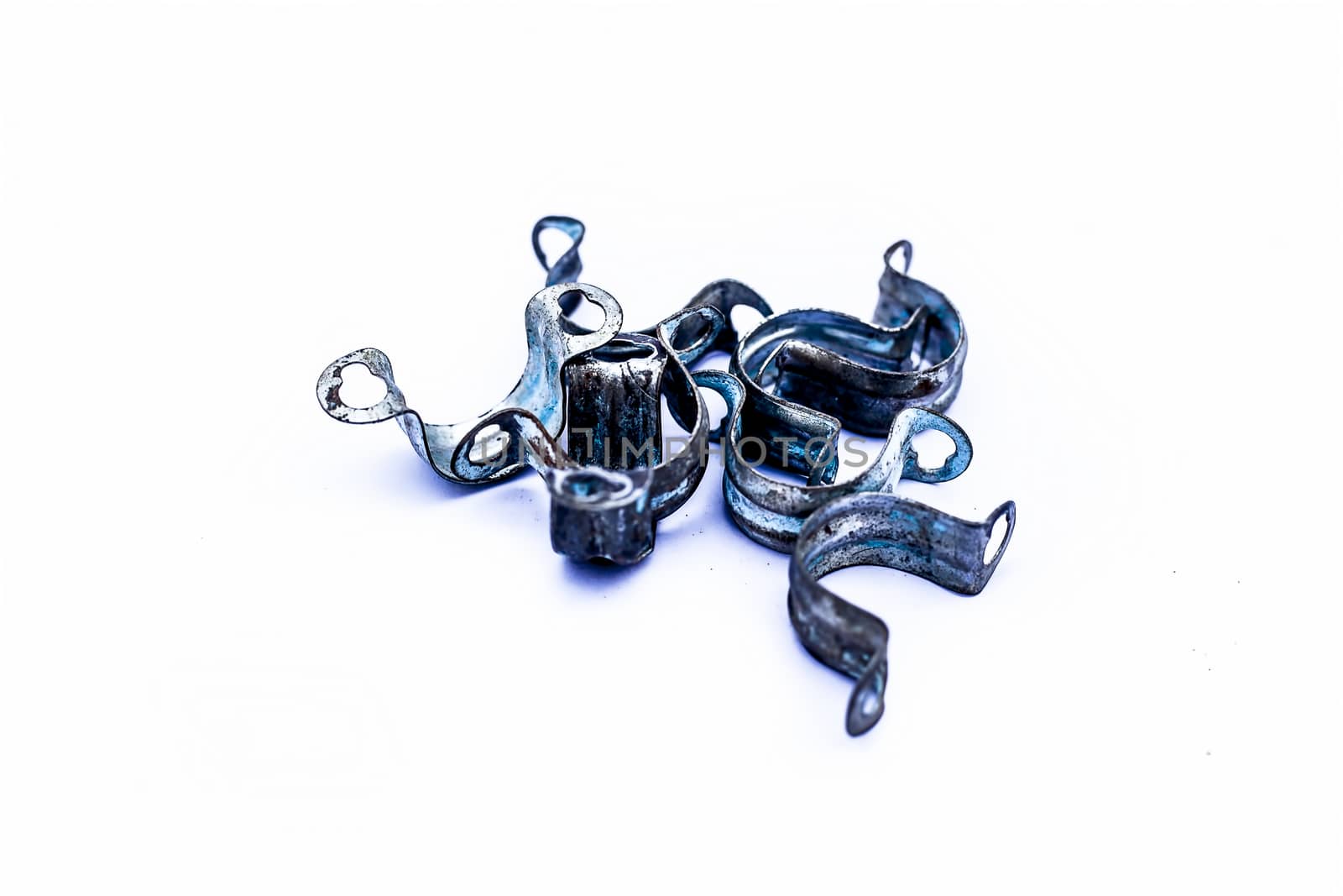 Close up of bunch of aluminum pipe clamp or clip isolated on white.