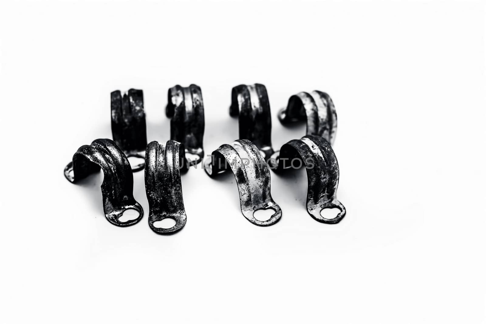Close up of bunch of aluminum pipe clamp or clip isolated on white.