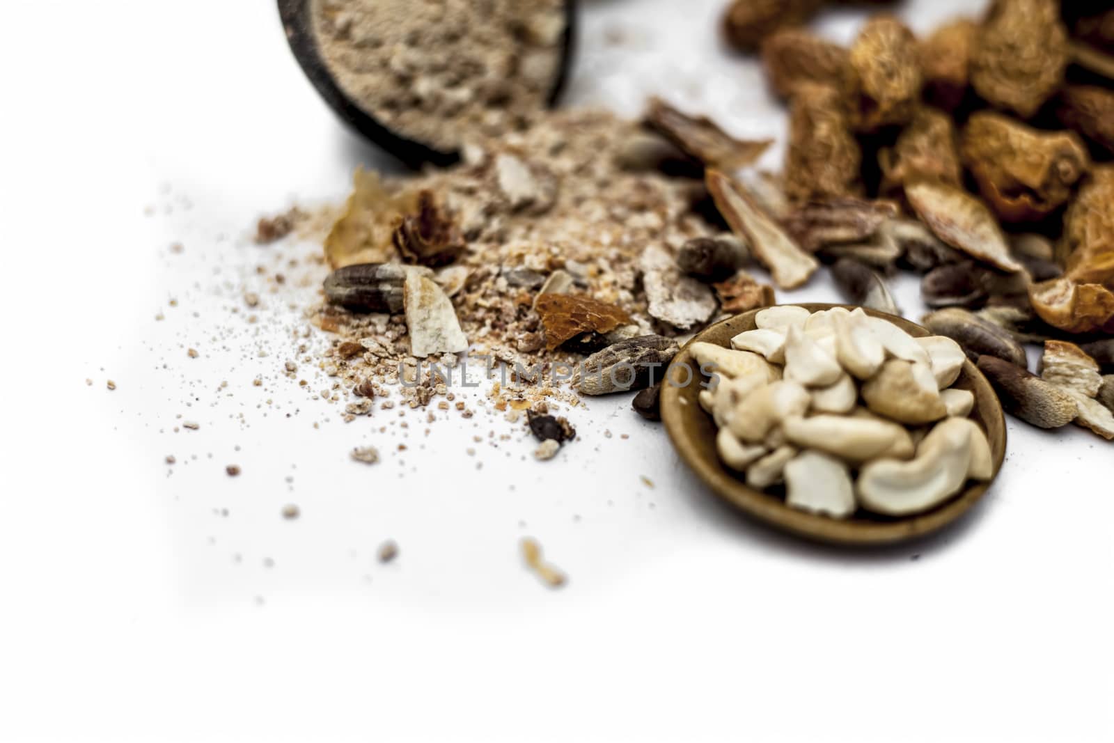 Close up of popular Indian and asian Winter drink isolated on white i.e. Kharek ka dudh or dried dates milk consisting of milk,dried dates,cashews,almonds dry fruits and sugar.