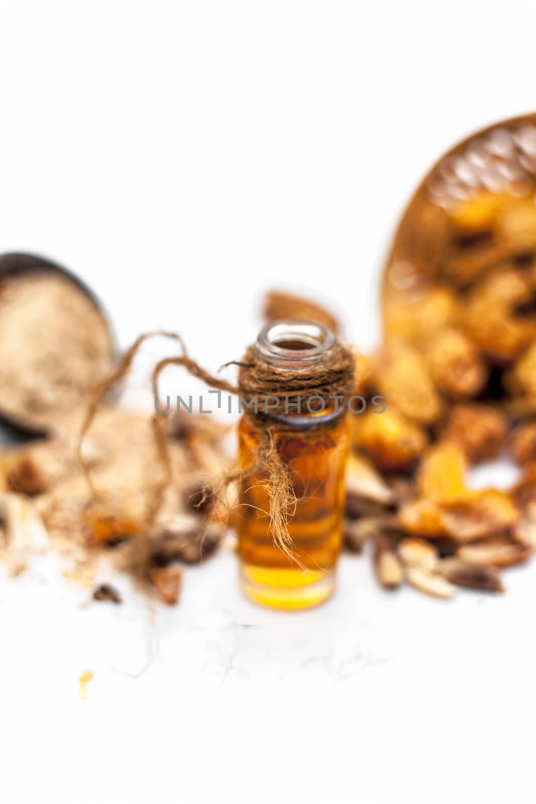 Essential oil of kharek of dried dates or sukhi khajoor or Phoenix dactylifera in a transparent glass bottle isolated on white with raw dried dates and its powder. by mirzamlk