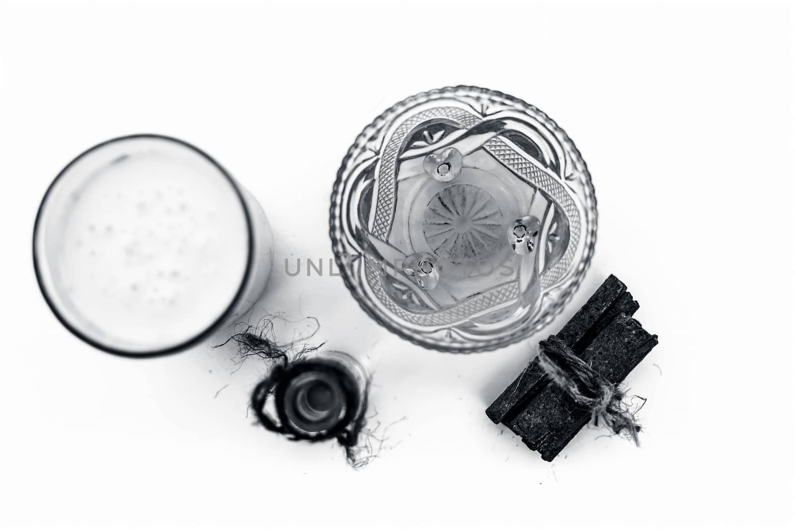 Close up of popular Indian & Asian winter drink isolated on white i.e Honey milk or shahad ka dudh in a transparent glass with entire ingredients which are milk,honey, and dry fruits.