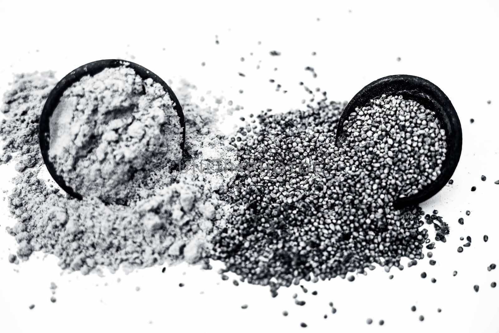 Close up of clay bowl of barley or pearl millet with its flour in a another bowl isolated on white.