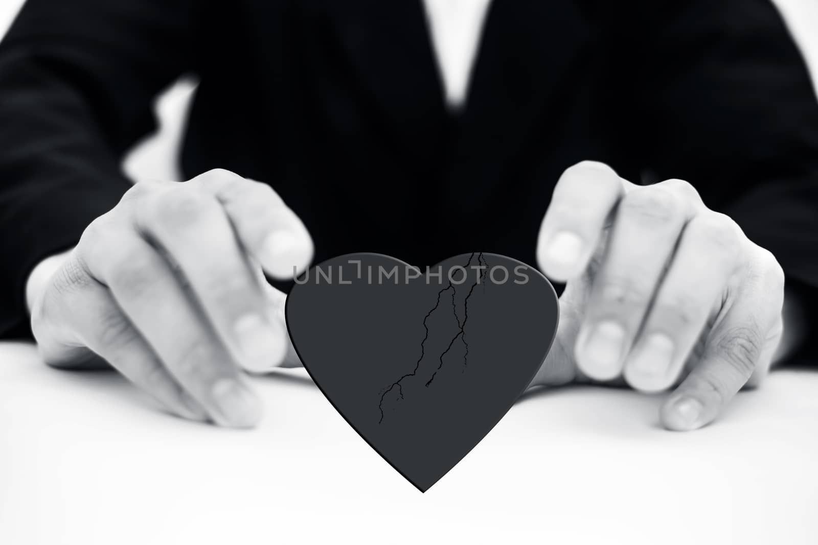 Close up of hands of business man or employee wearing blue colored suit and trying to save heart isolated.Concept of having peace and working without discrimination. by mirzamlk