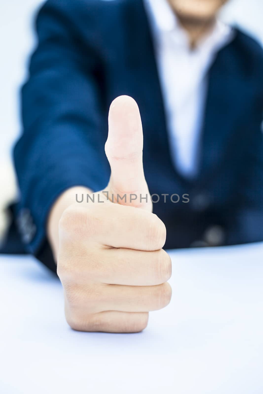 Close up of hand of business man showing thumbs up or showing happiness via hand gesture isolated on white.