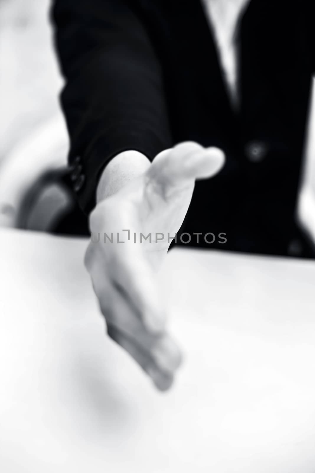 Close up of businessman's hand giving or wanting to hand shake or collaborating concept isolated on white.