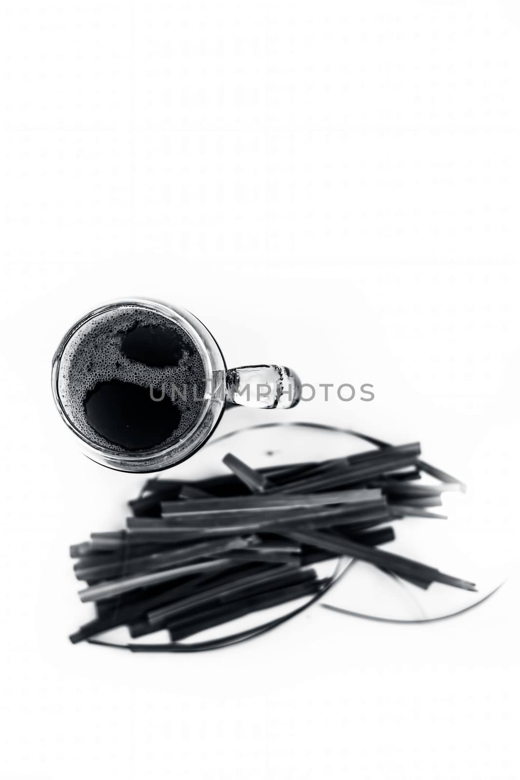 Close up of fresh organic extracted juice of lemon grass isolated on white in a transparent glass with raw Indian lemon grass or lili chai or Cymbopogon.