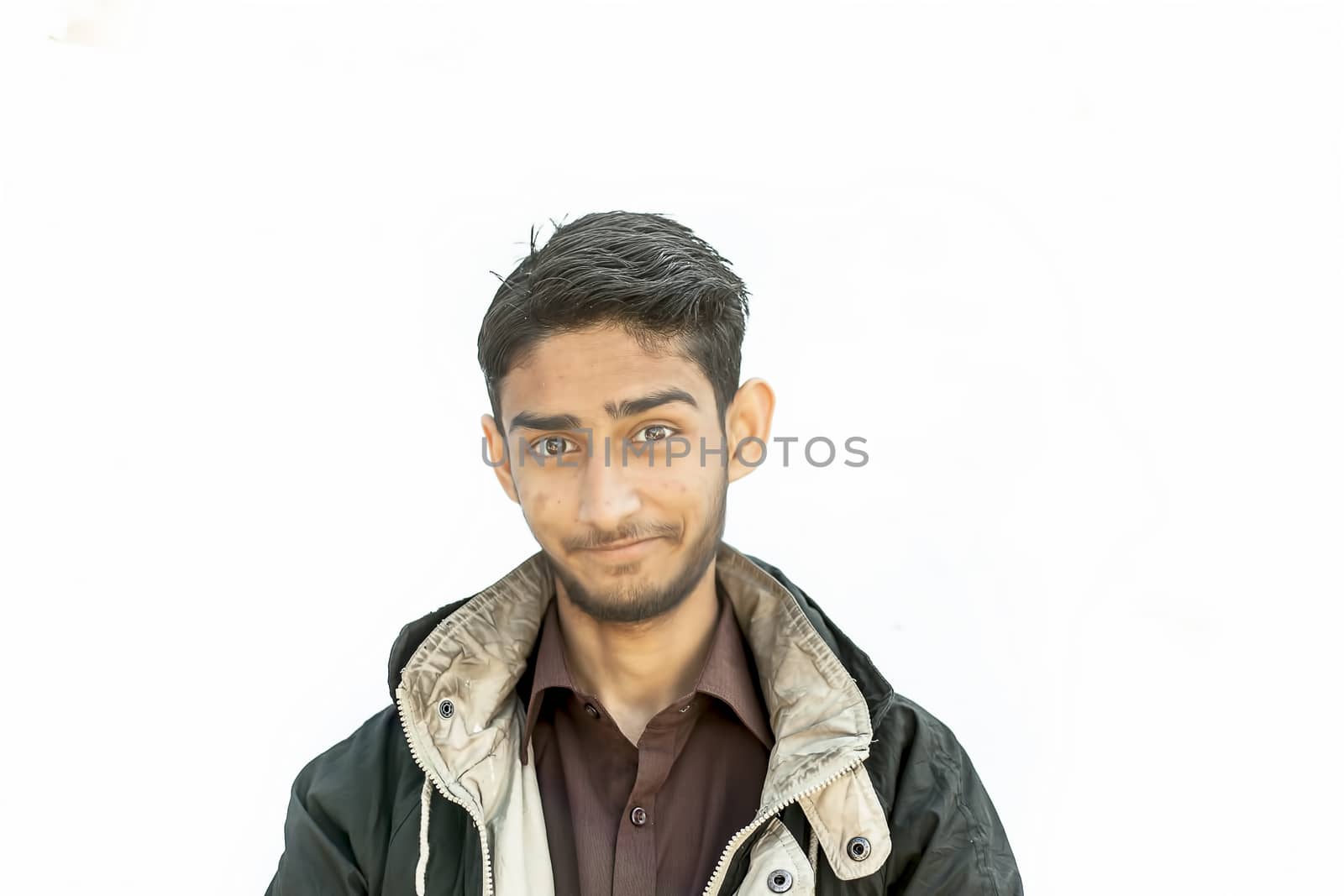 Portrait shot of a young beard man wearing brown colored shirt and a black colored jacket expressing or looking at the camera by surprised face or with curiosity or sometimes hilarious faces. by mirzamlk