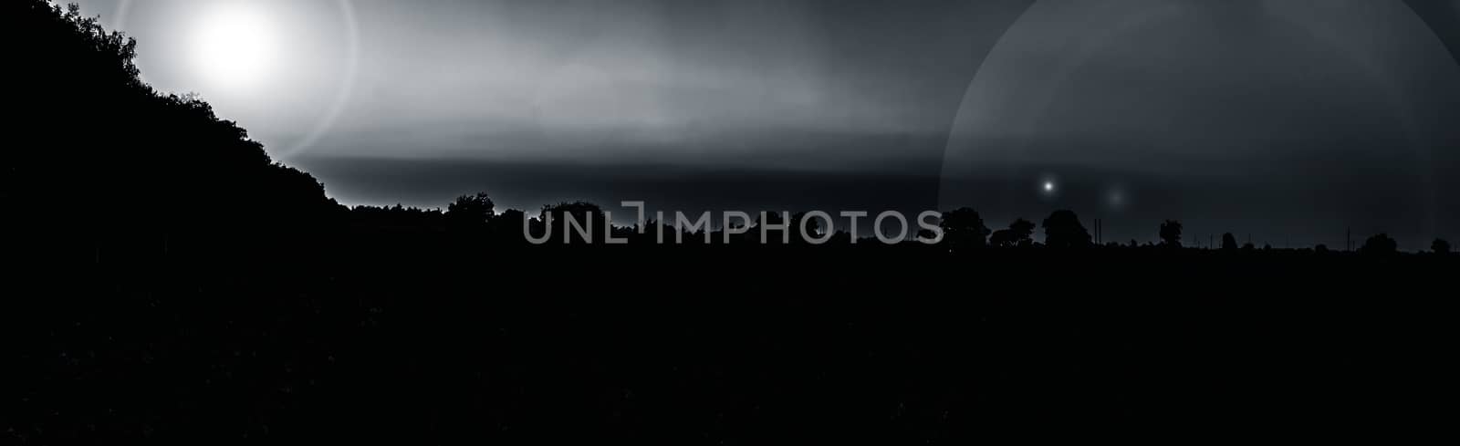 Panorama shot of sunset or sunrise through clouds and mountains and trees in the deep forest. by mirzamlk
