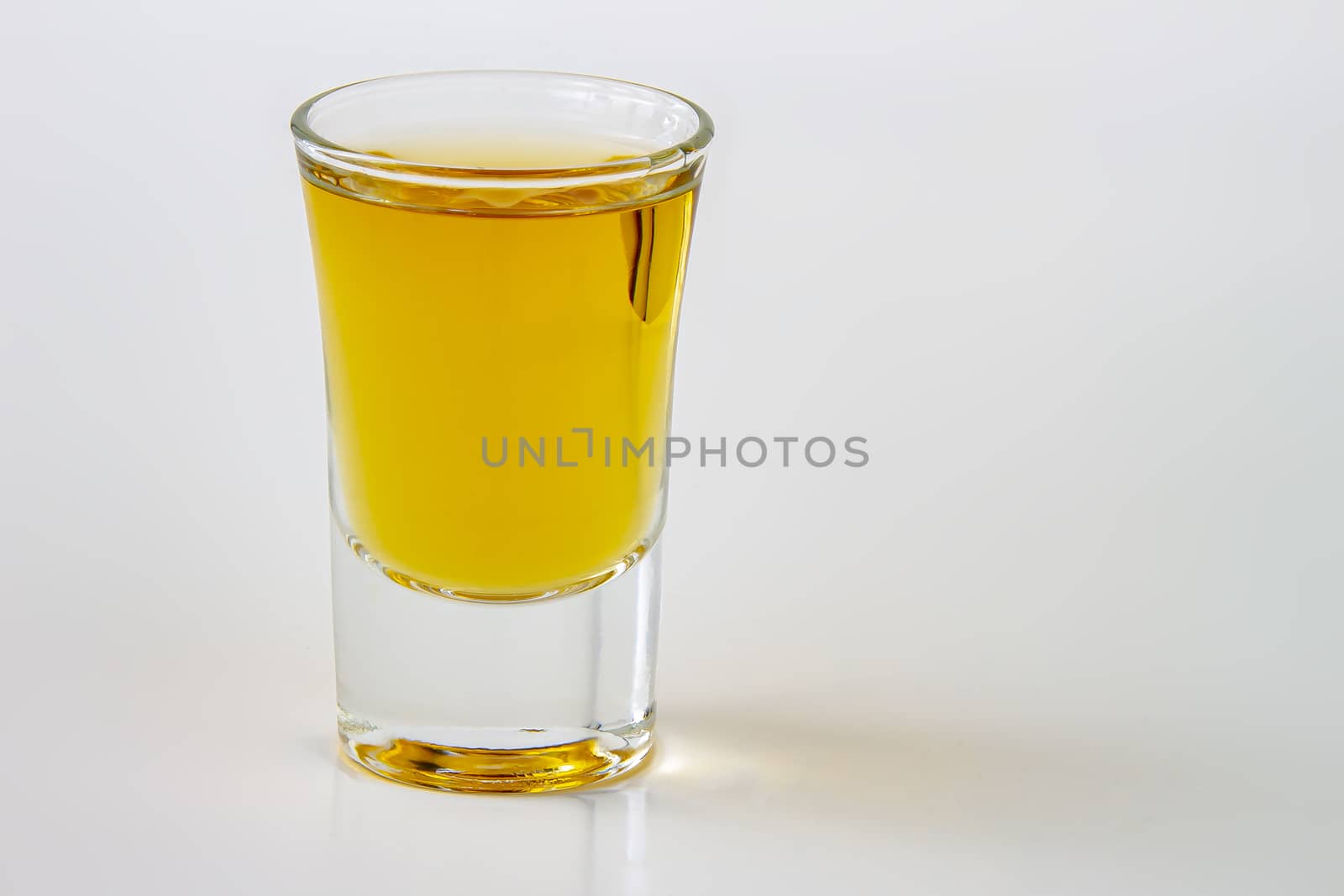 A horizontal view of a liquor shot drink on a white background by oasisamuel