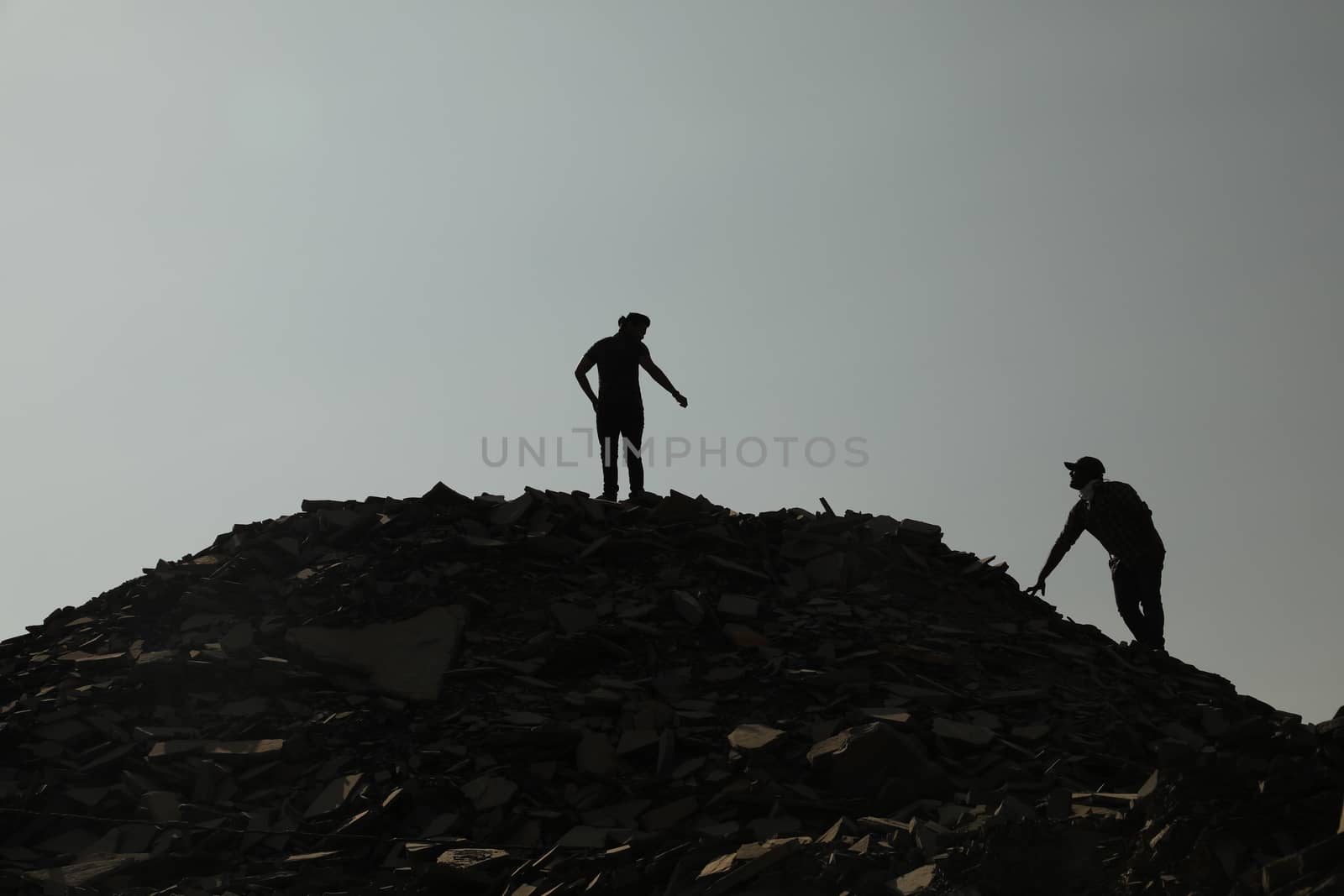 Silhouette of people on hill