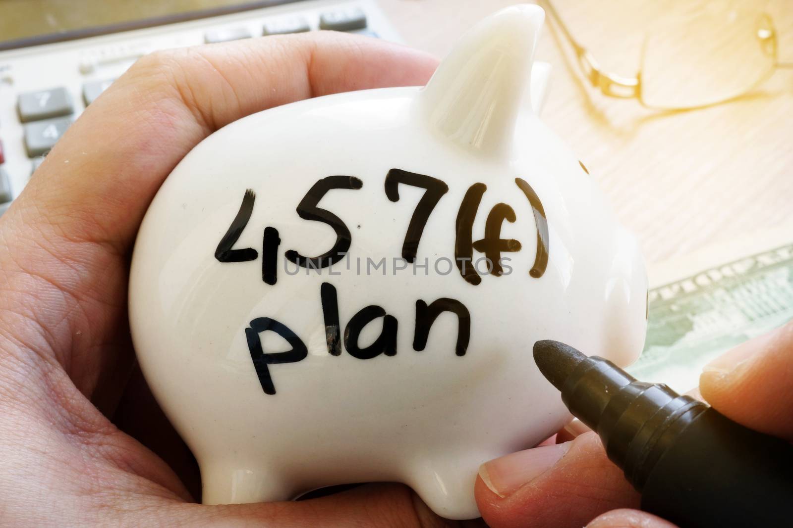 Piggy bank with sign 457f plan. Pension plan.