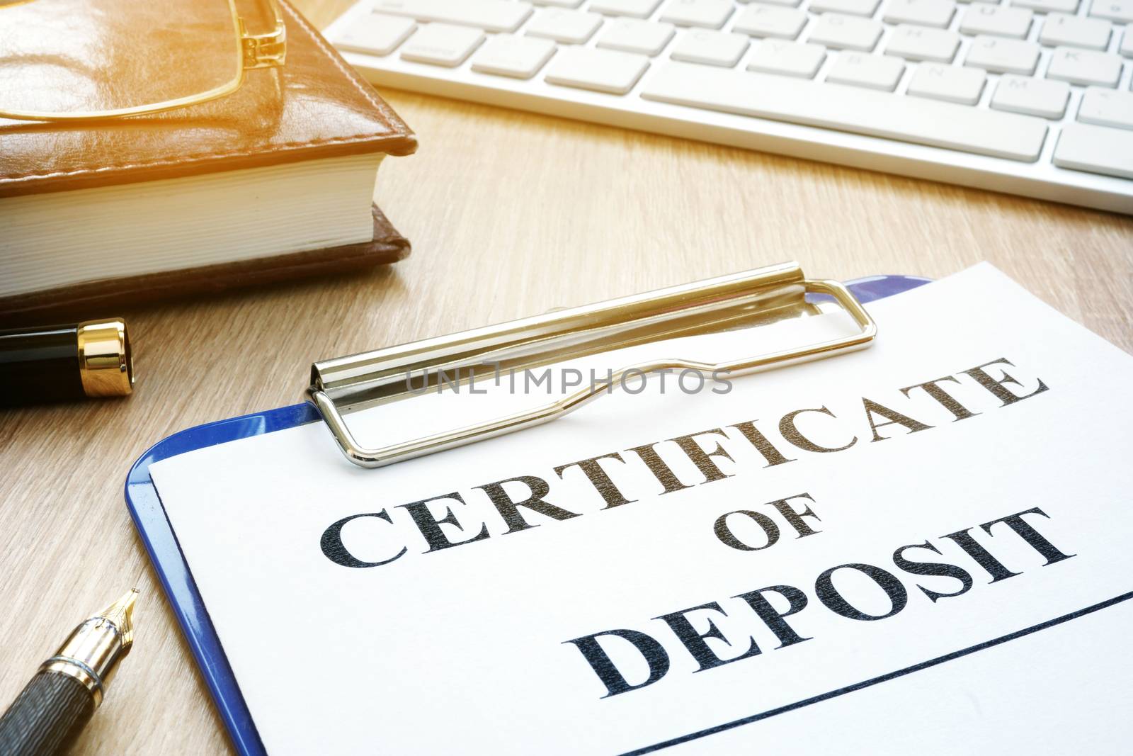 Certificate of deposit and pen on a desk.
