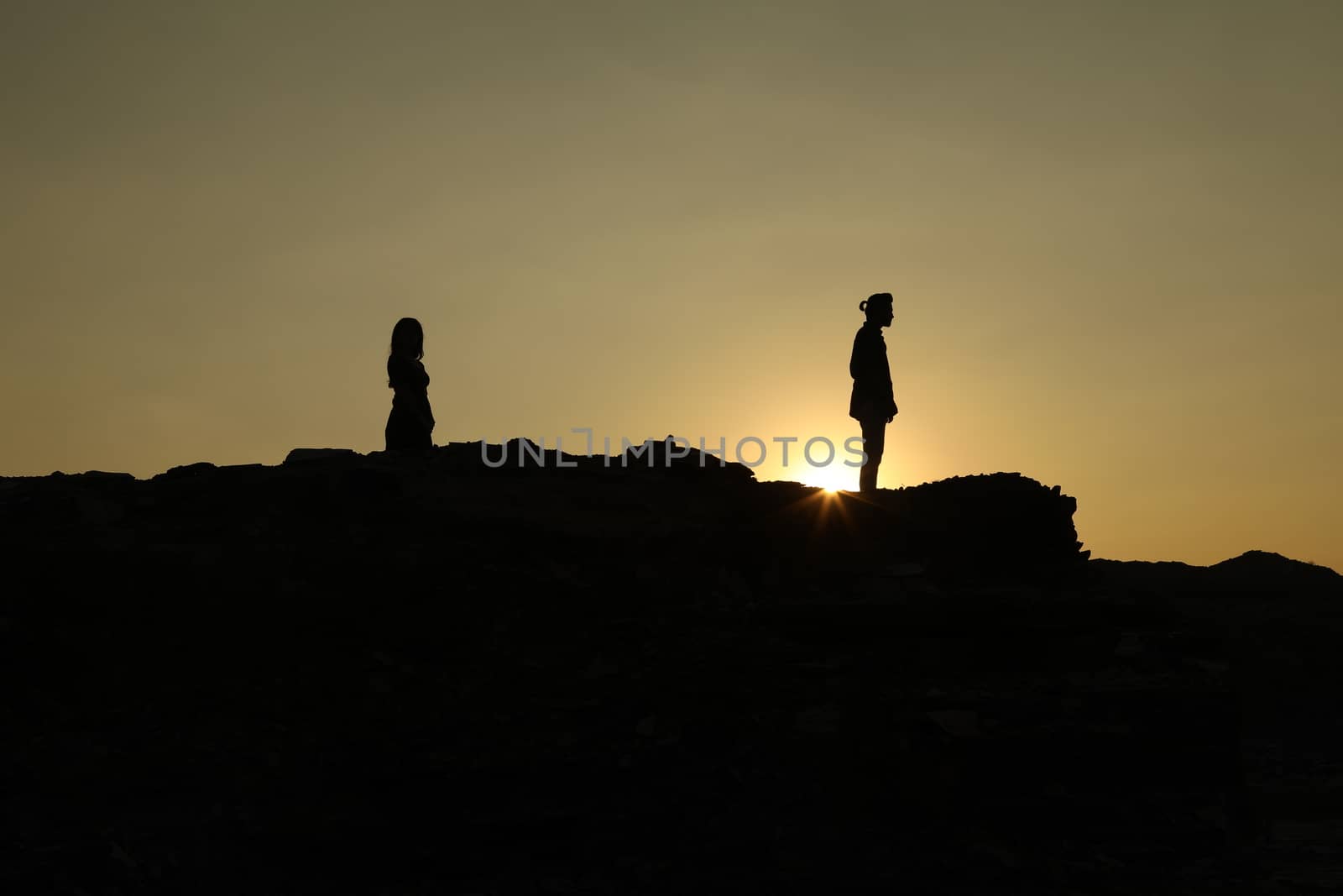 Silhouette of people on hill