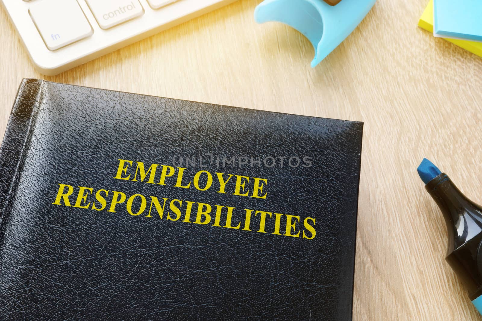 Book about Employee responsibilities on an office table.