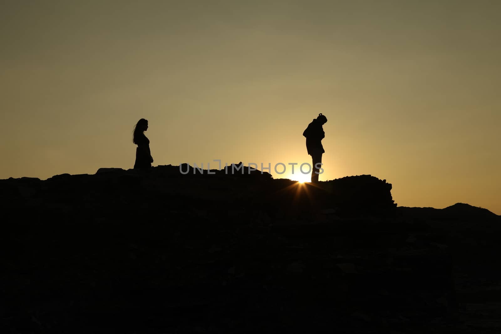 Silhouette of people on hill