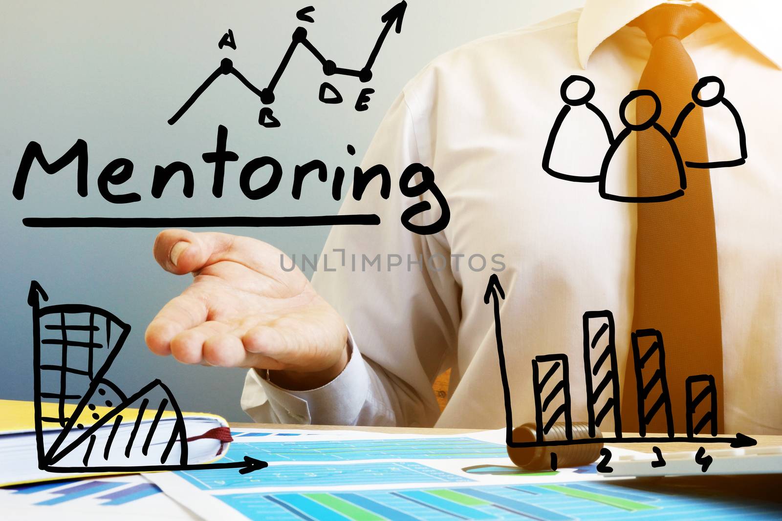 Mentoring concept. Mentor at the table in the office.