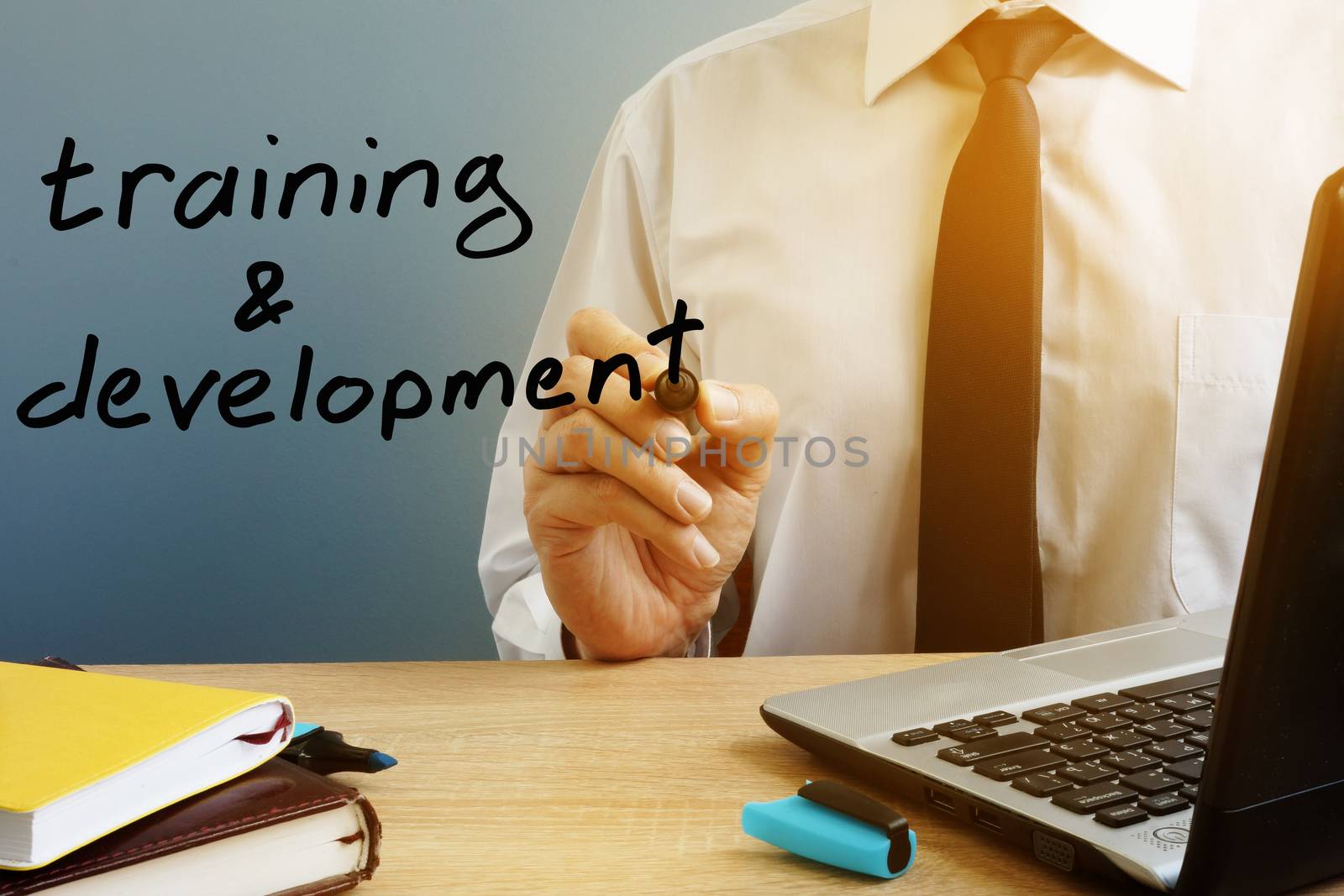 Training and development. Mentor with marker at the office table.