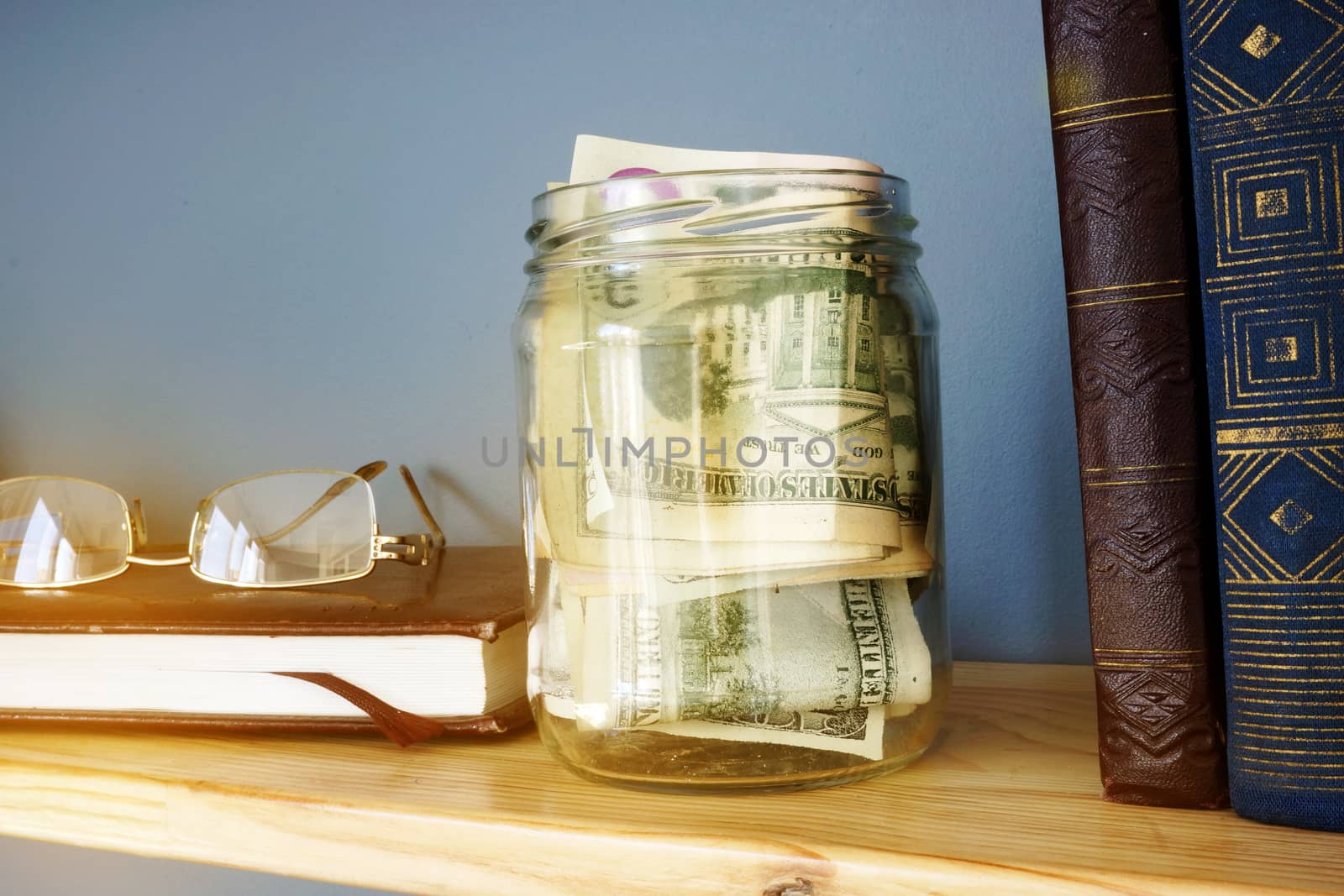 Jar with money on a shelf. Savings and home finances.