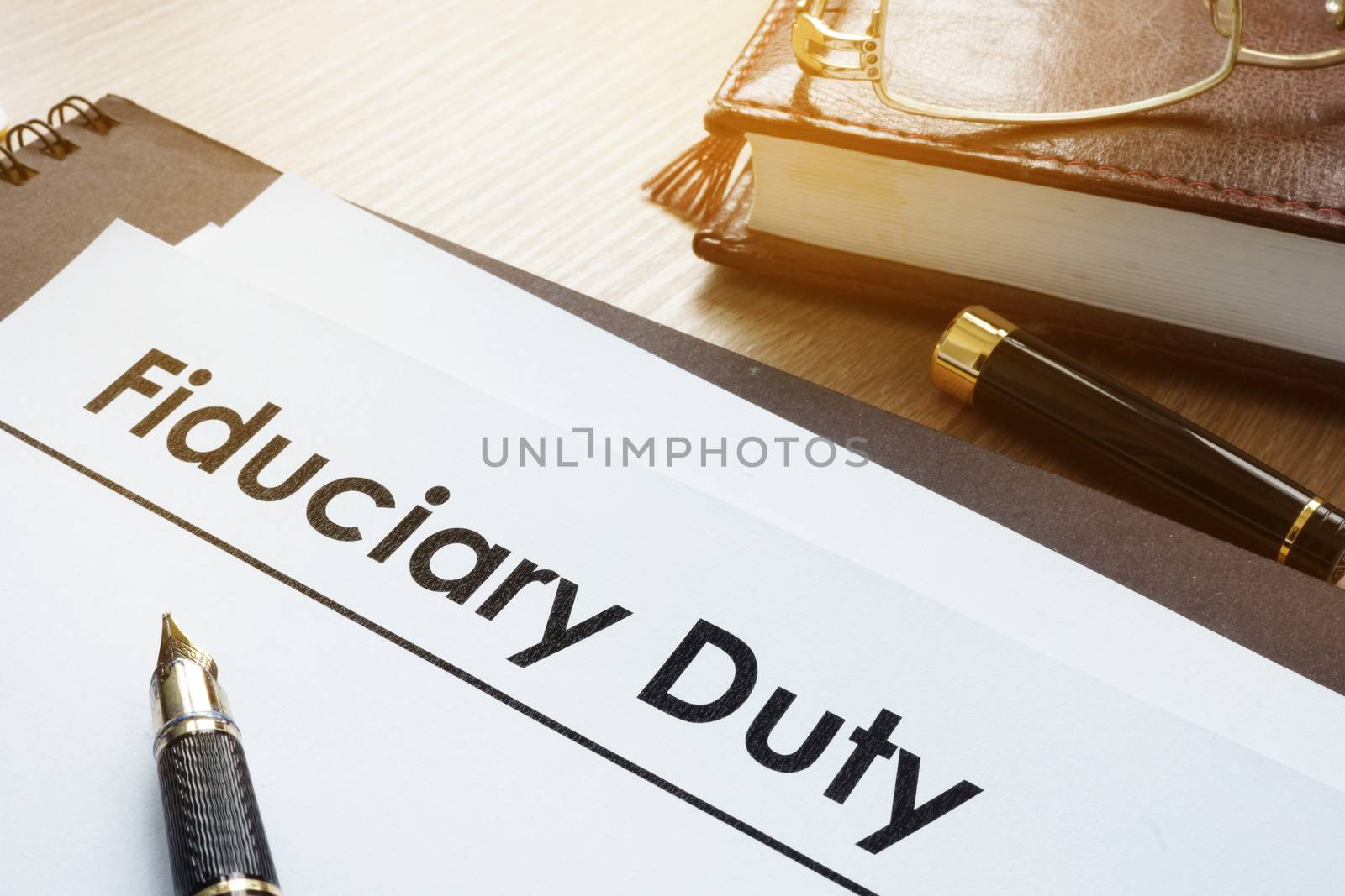 Documents with title fiduciary duty on a desk.