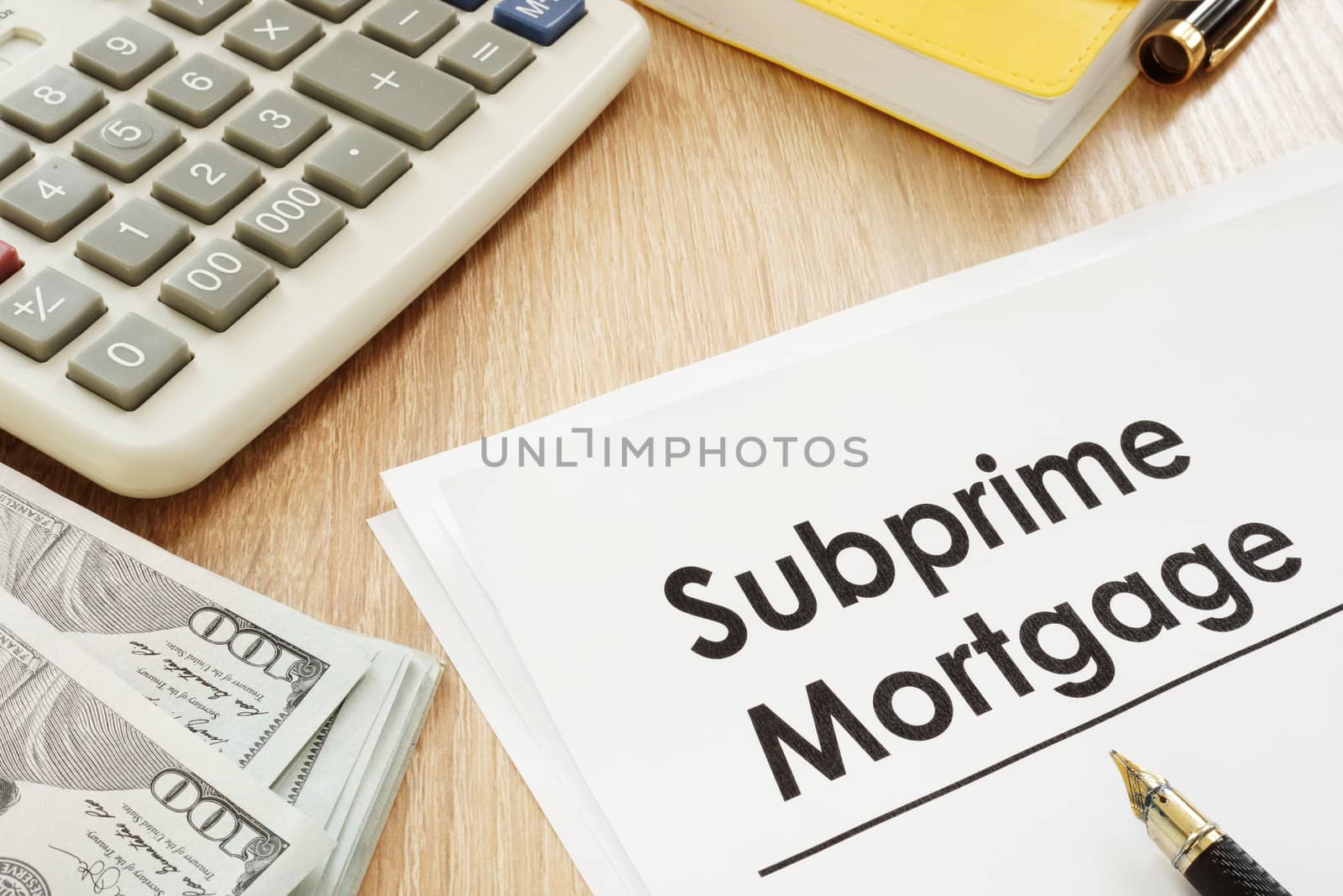 Subprime mortgage form, calculator and pen.