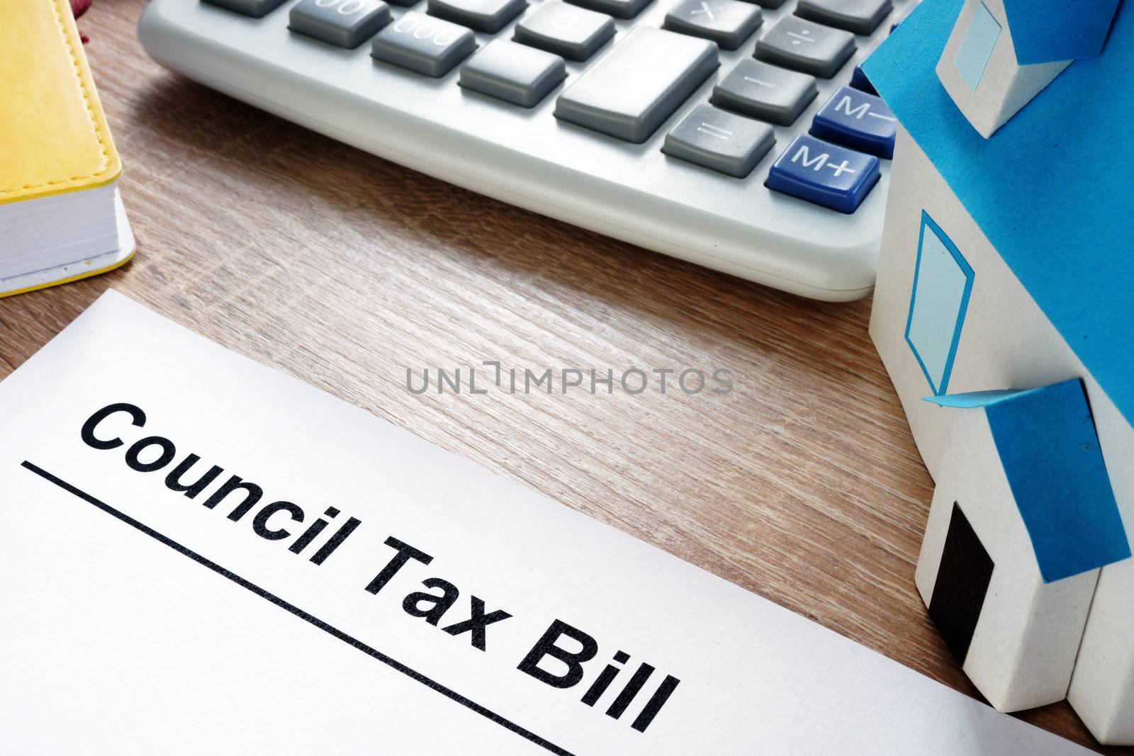 Council Tax Bill and model of house on a desk.
