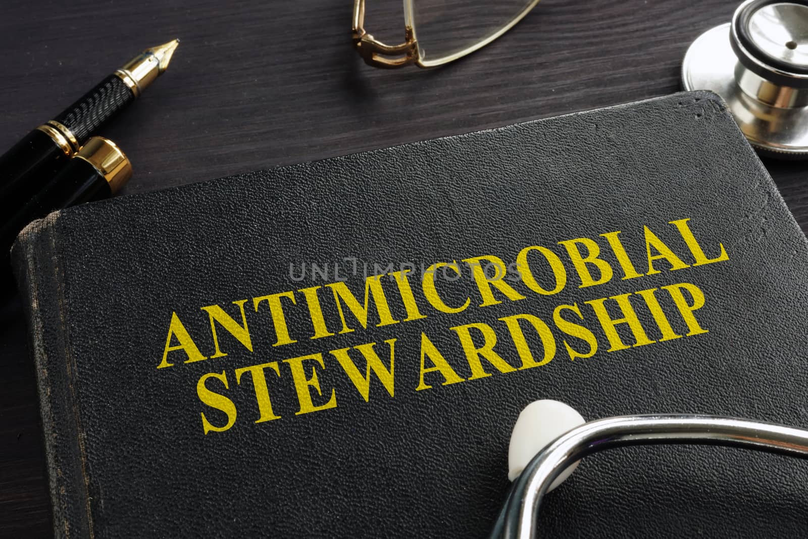 Book about Antimicrobial stewardship (AMS) and stethoscope.