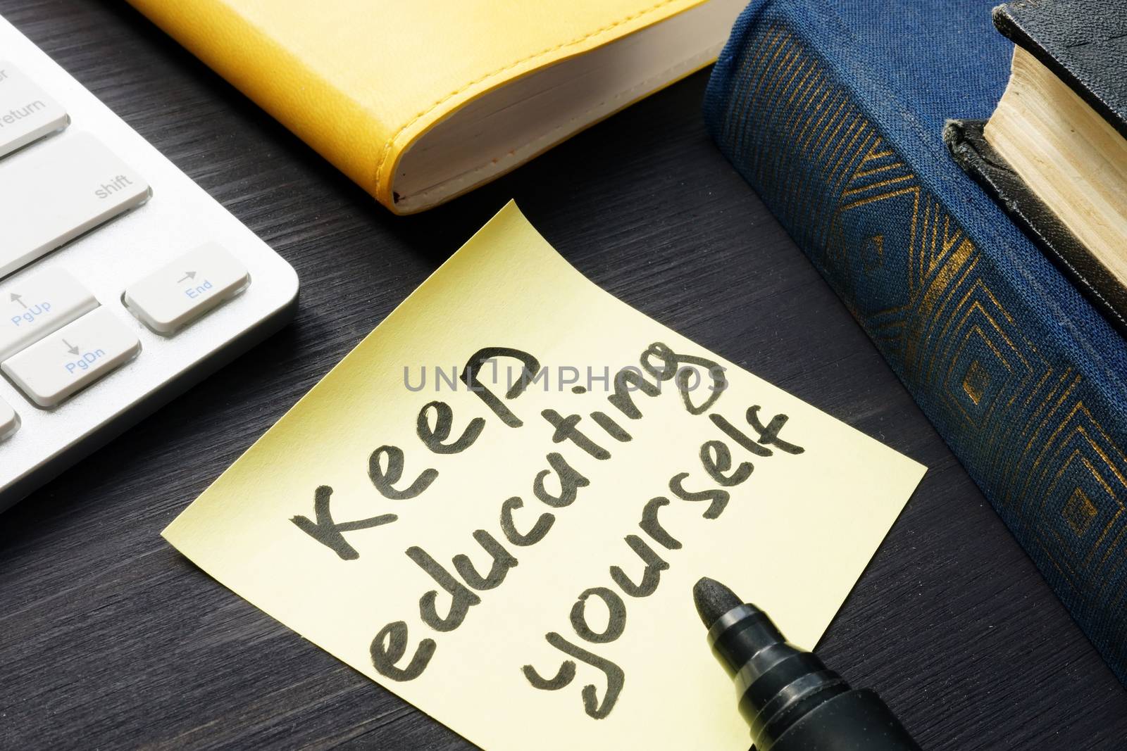 Keep educating yourself. Book and keyboard. Lifelong learning.
